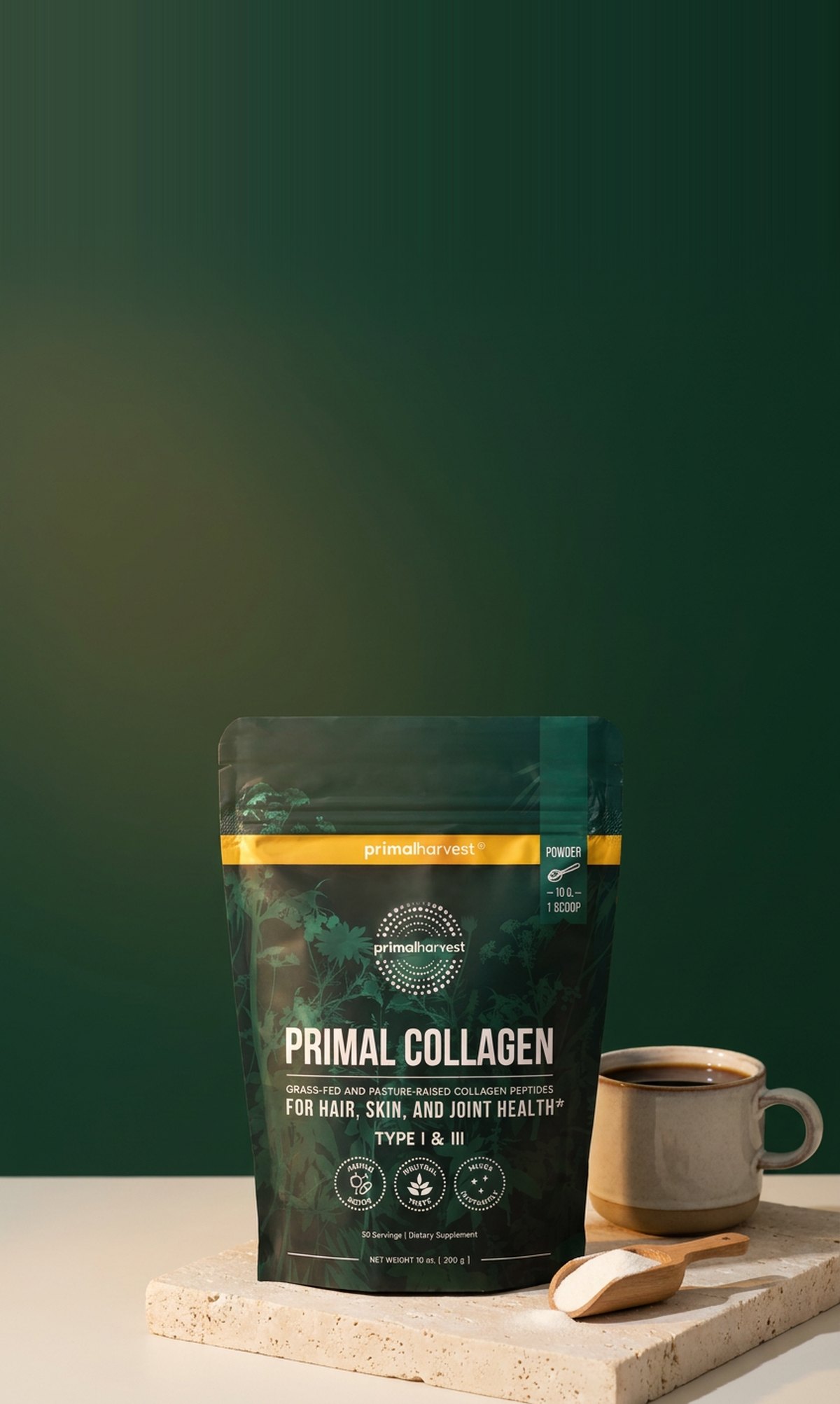The Primal Collagen pouch on a stone block next to a mug of coffee